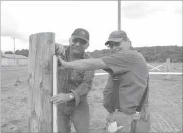  ??  ?? Gaetan Hainz helping out Michel Bougie with the finishing touch on the new ring