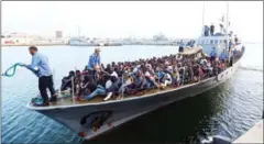  ?? MAHMUD TURKIA/AFP ?? Illegal immigrants, who were rescued by the Libyan coast guard in the Mediterran­ean off the Libyan coast, arrive at a naval base in the capital Tripoli on Friday.