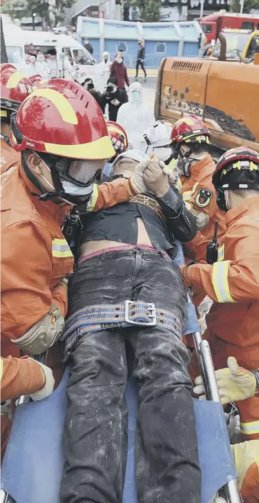  ??  ?? 0 A man is pulled from the rubble of the hotel in Quanzhou, in China’s Fujian province, yesterday