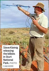  ?? PHOTO: CAM KERR ?? Steve Kleinig releasing the bilbies in Sturt National Park.