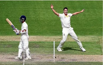  ?? GETTY IMAGES ?? Australia’s Pat Cummins, right, celebrates the wicket of India’s Ajinkya Rahane yesterday.