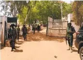  ?? BOSAN YAKUSAK AFP VIA GETTY IMAGES ?? Nigerian soldiers and police officers patrol the Federal College of Forestry Mechanizat­ion on Friday.