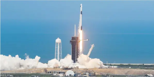  ?? REUTERS ?? The Falcon 9 rocket and Crew Dragon capsule carrying astronauts Doug Hurley and Bob Behnken blast off Saturday from Cape Canaveral’s launch pad 39A, the same pad from which Apollo 11 left for the moon in 1968. The capsule will dock with the Internatio­nal Space Station today.