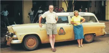  ?? COURTESY SCOTT HALDEMAN ?? Joshua Haldeman with his wife, Winnifred, and the vehicle they used to compete in the Cape to Algiers motor rally in Africa, in which they tied for first place.