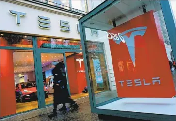  ?? SEAN GALLUP Getty Images ?? TESLA’S results were boosted by a revenue spike that is unlikely to be repeated. Above, a showroom in Berlin.