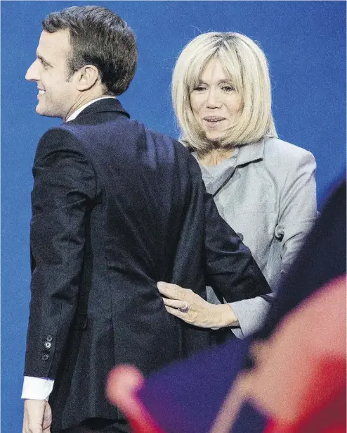  ?? CHRISTOPHE MORIN / BLOOMBERG ?? Emmanuel Macron and his wife, Brigitte, arrive to deliver a speech after the first round of the French presidenti­al election. The independen­t candidate faces a runoff against former National Front leader Marine Le Pen.