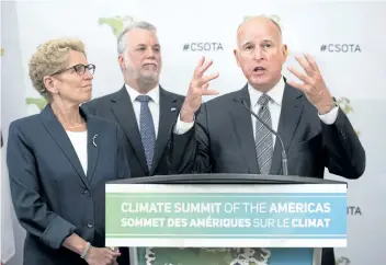  ?? DARREN CALABRESE/THE CANADIAN PRESS ?? California Gov. Jerry Brown speaks to reporters while Ontario Premier Kathleen Wynne, left, and Quebec Premier Philippe Couillard listen at the Climate Summit of the Americas in Toronto in 2015.