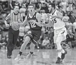  ?? AP Photo/L.G. Patterson ?? ■ Texas A&M’s Chris Collins, left, is defended by Missouri’s Jordan Geist, right, as he brings the ball up the court during the first half of an NCAA basketball game Tuesday in Columbia, Mo.