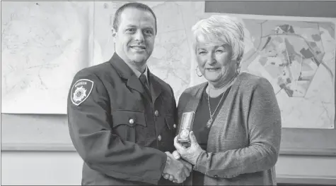  ?? COLIN CHISHOLM ?? Lieutenant Daniel Lavers receives a medal for his 16 years of service with the Windsor Fire Department from Mayor Anna Allen.