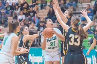  ?? EDDIE MOORE/JOURNAL ?? Pojoaque Valley’s Ashten Martinez, center, moves toward the basket after a rebound in a home game against St. Pius last Tuesday. The Elkettes won 44-17.