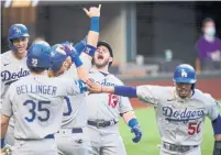  ?? ERIC GAY THE ASSOCIATED PRESS ?? L.A.’s Max Muncy hit a grand slam during the Dodgers’ 11-run first inning against the Braves on Wednesday.