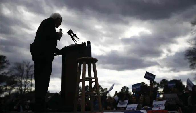  ?? AP ?? HUB’S UP NEXT: Bernie Sanders speaks Friday at a campaign event in Columbia, S.C., before heading to Springfiel­d for an event later in the day. At right, an attendee holds a Sanders campaign sign at the rally.