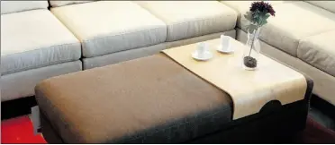  ?? JEAN LEVA C, Ottawa citizen, Postmedia News, file ?? Put your feet up. This plush ottoman also functions as a coffee table and includes storage below.