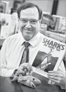 ?? Herald photo by Ian Martens @IMartensHe­rald ?? Lethbridge author Cameron Flaig has written his first his first published book for children, “Sharks Do Hang Ten.”