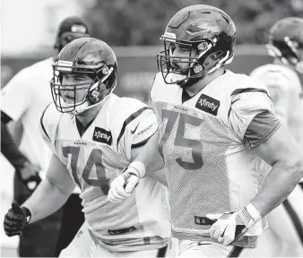  ?? Photos by Brett Coomer / Staff photograph­er ?? The Texans are counting on Max Scharping (74) and Matt Kalil (75) to help give quarterbac­k DeshaunWat­son more protection this season. Watson was sacked 62 times last year.