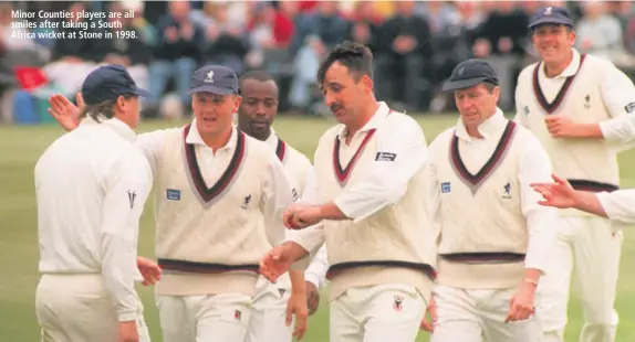  ??  ?? Minor Counties players are all smiles after taking a South Africa wicket at Stone in 1998.