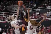  ?? JEFF CHIU — THE ASSOCIATED PRESS ?? Stanford forward Cameron Brink, left, blocks a shot attempt by Arizona State guard Jalyn Brown, middle, as guard Jzaniya Harriel (32) defends during the first half Sunday in Stanford.
