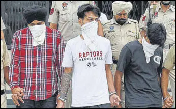  ?? AFP ?? Police personnel escort the suspects to a court at Patti in Tarn Taran district on Thursday .