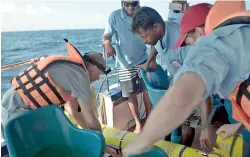  ??  ?? Challenger being taken onboard the whale-watching boat