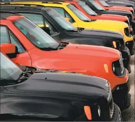  ?? Joe Raedle Getty Images ?? JEEP RENEGADES at a dealership in Hollywood, Fla. The automaker’s Gladiator — the truck version of the rugged Wrangler model — can easily fetch $50,000.