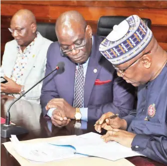  ?? PHOTO: ?? From left: President, Nigerian University Games Associatio­n (NUGA), Prof. Stephen Hamafyelto; Vice Chancellor, University of Lagos, Prof. Oluwatoyin Ogundipe; and Chairman LOC/President, UNILAG Alumni Associatio­n, Mr. John Momoh, during the signing of a memorandum of understand­ing between UNILAG and NUGA on the forthcomin­g 2019 NUGA games in Lagos on Friday Benedict Uwalaka