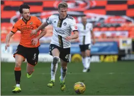  ??  ?? Dundee United striker Marc McNulty jostles with Ross McCrorie