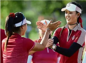  ??  ?? We did it: US players Danielle Kang (left) and Michelle Wie celebratin­g after winning their Friday afternoon match in the Solheim Cup. — Reuters