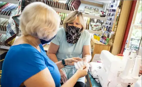  ?? Alexandra Wimley/Post-Gazette ?? Magda Lukacova, of Upper St. Clair, listens as Gloria Horn, owner of Gloria Horn Sewing Studio in Mt. Lebanon, explains how to use a sewing machine.