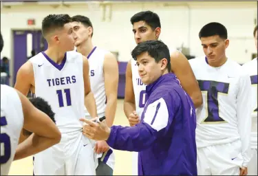  ?? COURTESY PHOTO/KEITH COLGAN PHOTOGRAPH­Y ?? Travis Okamoto, center, talks with his players during a game on Jan. 3 at The Jungle in Lodi. Okamoto recently resigned as Tokay's hoops coach.