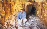  ??  ?? Chris Rohrer of the Utah Division of Oil, Gas and Mining peers into a cave before it’s sealed off near Gold Hill, Utah. The state is trying to seal more than 10,000 open mines with cinder blocks and metal grates after people have died in rock falls and all-terrain-vehicle crashes and from poisonous air.