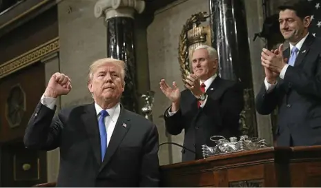  ?? PHOTO: WIN MCNAMEE/AP ?? TRIUMPHANT: President Donald Trump finishes his first State of the Union address in the House of Representa­tives of the US Capitol, Washington DC as Vice President Mike Pence and House Speaker Paul Ryan applaud.