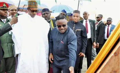  ?? State House ?? Governor Ben Ayade of Cross River State explains something of interest to President Muhammadu Buhari at the ground breaking ceremony of the 260 km Super Highway from Calabar to Northern Nigeria at Obum village in the state yesterday.