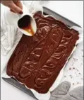  ??  ?? Caramel sauce is drizzled onto the brownie batter.