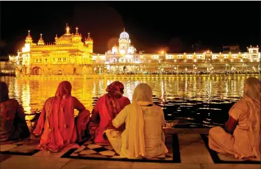  ?? IANS ?? A view of the illuminate­d Golden Temple on the eve of Baisakhi in Amritsar, on Friday.