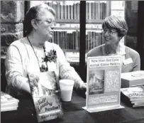  ?? Elaine Perkins (left) signs copies of her book on Western Travis County history with Bee Cave librarian Mary Miller at Bee Cave’s 25th anniversar­y celebratio­n Dec. 12. LAKE TRAVIS VIEW ??