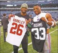  ?? Rich Grassle/ Icon Sportswire via Getty Images ?? The Jets’ Jamal Adams, left, and the Giants’ Saquon Barkely pose after swapping jerseys following a November game. The postgame tradition is now banned by the NFL as part of its coronaviru­s protocols.