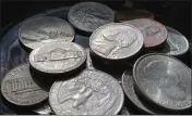  ?? JENNY KANE — THE ASSOCIATED PRESS ?? Quarters, nickels, dimes and pennies are held a bowl Thursday in Tigard, Ore.