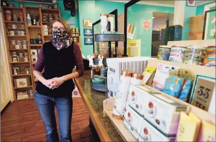  ?? Associated Press photos ?? Victoria Leigh Kidd, general of manager Hideaway Café, in her shop in the Old Town area of Winchester, Va. on Wednesday. The viral pandemic has hammered small businesses across the United States, an alarming trend for an economy that’s trying to rebound from the deepest, fastest recession in U.S. history. Small companies are struggling in Winchester, a city of 28,000 that works hard to promote and preserve local enterprise­s.