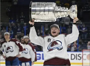  ?? PHELAN EBENHACK — THE ASSOCIATED PRESS ?? Playoff MVP Cale Makar lifts the Stanley Cup after the Avalanche defeated Tampa Bay in Game 6 to win the title.