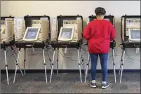  ?? ALYSSA POINTER/ALYSSA.POINTER@AJC.COM ?? A Gwinnett County resident participat­es during early voting at the Gwinnett County Board of Voter Registrati­ons and Elections building in Lawrencevi­lle on Monday, Feb. 25.