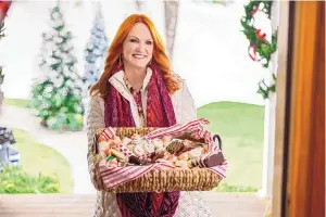  ?? ?? Ree Drummond as bakery owner Bee delivers a basket of treats to the Winterses for their annual holiday party in the Discovery+ holiday movie, “Candy Coated Christmas.”