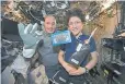  ?? NASA, via The Associated Press ?? Astronauts Luca Parmitano of Italy and Christina Koch of the United States show off a cookie baked on the Internatio­nal Space Station.