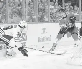  ?? JOEL AUERBACH/GETTY IMAGES ?? Mark Pysyk of the Panthers tries to get the puck past Ryan Hartman of the Blackhawks during Chicago’s 4-1 thumping of Florida on Saturday night.