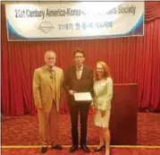  ?? DAN SOKIL - DIGITAL FIRST MEDIA ?? Korean Consul Kim Hyun-Joo receives a proclamati­on of honorary citizenshi­p of North Wales Borough from North Wales Mayor Greg D’Angelo, left, and Ambler Mayor Jeanne Sorg at the 21st Century America-Korea-China Leaders Society meeting Thursday in...