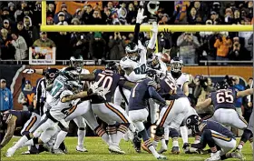  ?? AP/DAVID BANKS ?? Philadelph­ia lineman Treyvon Hester (middle) tipped Chicago kicker Cody Parkey’s field goal attempt just enough to send the ball bouncing off the upright and crossbar, securing the Eagles’ 16-15 victory over the Bears last week.
