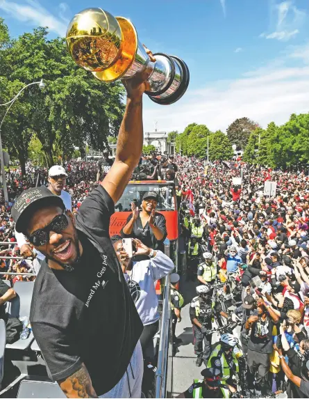  ?? FRANK GUNN / THE CANADIAN PRESS ?? Raptors forward Kawhi Leonard holds his playoffs MVP trophy during the 2019 Toronto Raptors Championsh­ip parade on Monday.