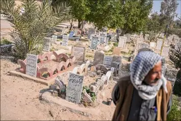  ?? Joao Silva / The New York Times ?? Kamil Jassim Mohammed is the custodian of the martyrs cemetery, in Fallujah, Iraq. About 200,000 civilians died during the strife, according to Brown University’s Cost of War project.