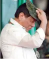  ?? AFP ?? President Duterte dons a Philippine Army ball cap at the 120th anniversar­y celebratio­n of the Philippine Army at Fort Bonifacio . —