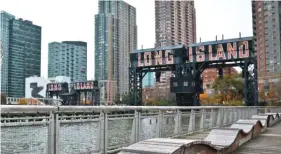  ?? BEBETO MATTHEWS/AP ?? “Long Island” is painted on old transfer bridges in Long Island City in New York. Officials say their deal to land a new Amazon headquarte­rs is a big win for the city, but the math is a little more complicate­d than government projection­s indicate.