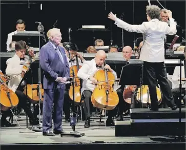  ?? Francine Orr Los Angeles Times ?? VIN SCULLY, left, with Gustavo Dudamel conducting Aaron Copland’s “Lincoln Portrait,” called his chance to narrate the powerful words from the nation’s 16th president “one of the most thrilling moments of my life.”